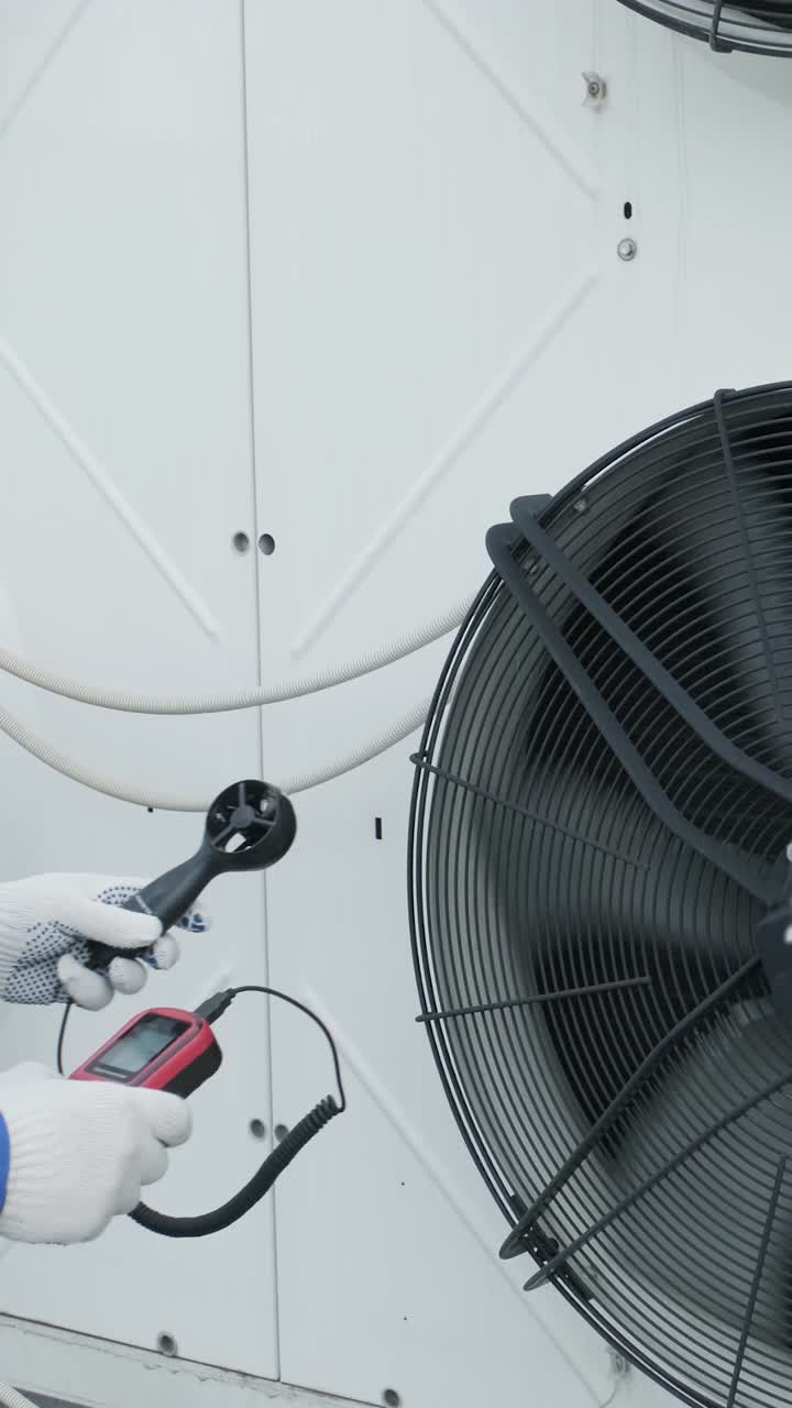HVAC Technician Inspecting Industrial Fan