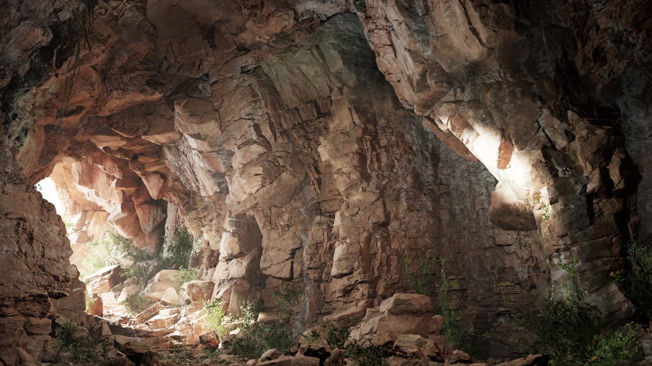 una cueva oscura con una luz brillando a través de la entrada