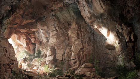 a dark cave with a light shining through the entrance