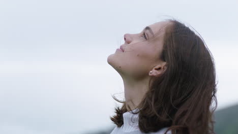 portrait of happy woman looking up smiling enjoying freedom outdoors exploring wanderlust contemplating spiritual journey in countryside breathing fresh air feeling positive