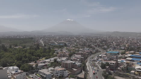 sideways drone shot above arequipa peru on a bright day with some mist with view on the mountain log