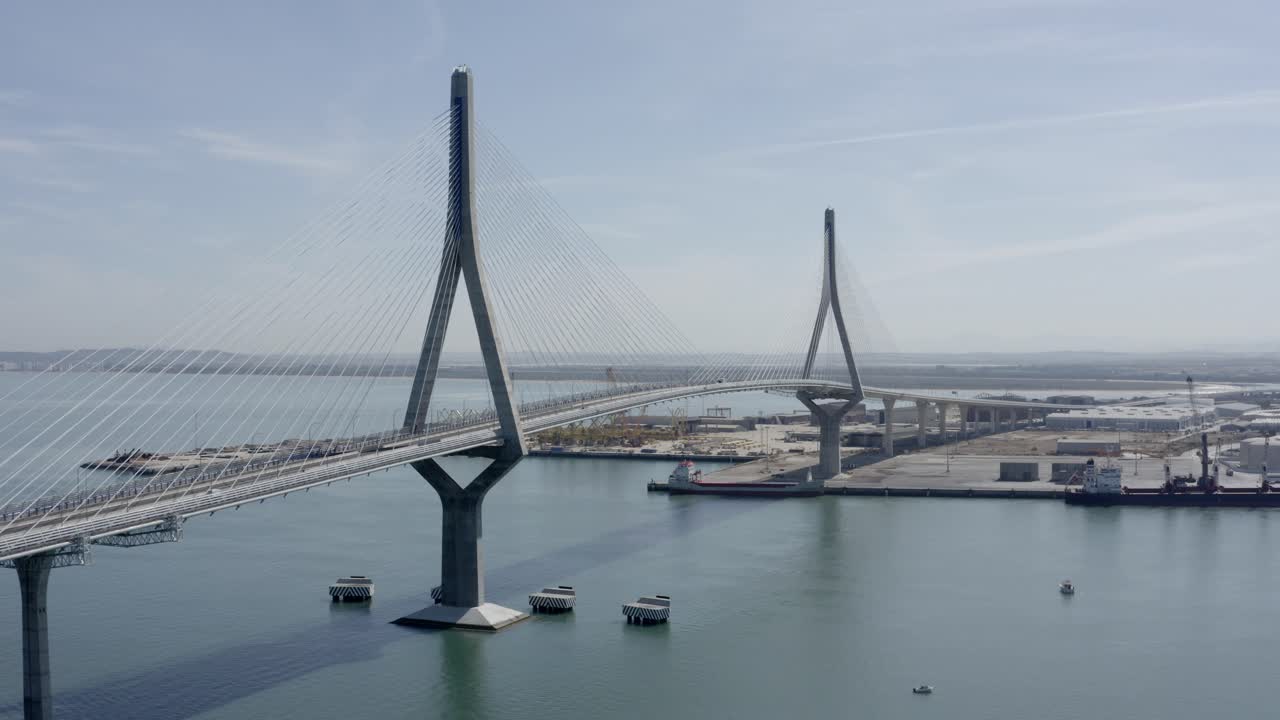 Aerial view of a cable-stayed bridge over a port
