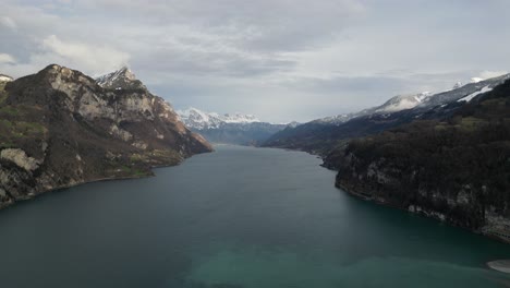 high aerial overview in middle of lake walen, walensee switzerland