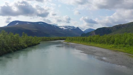 Drone-shot-of-Sweden-wilderness-in-summer-in-Scandinavia-with-cloudy-sky-and-river