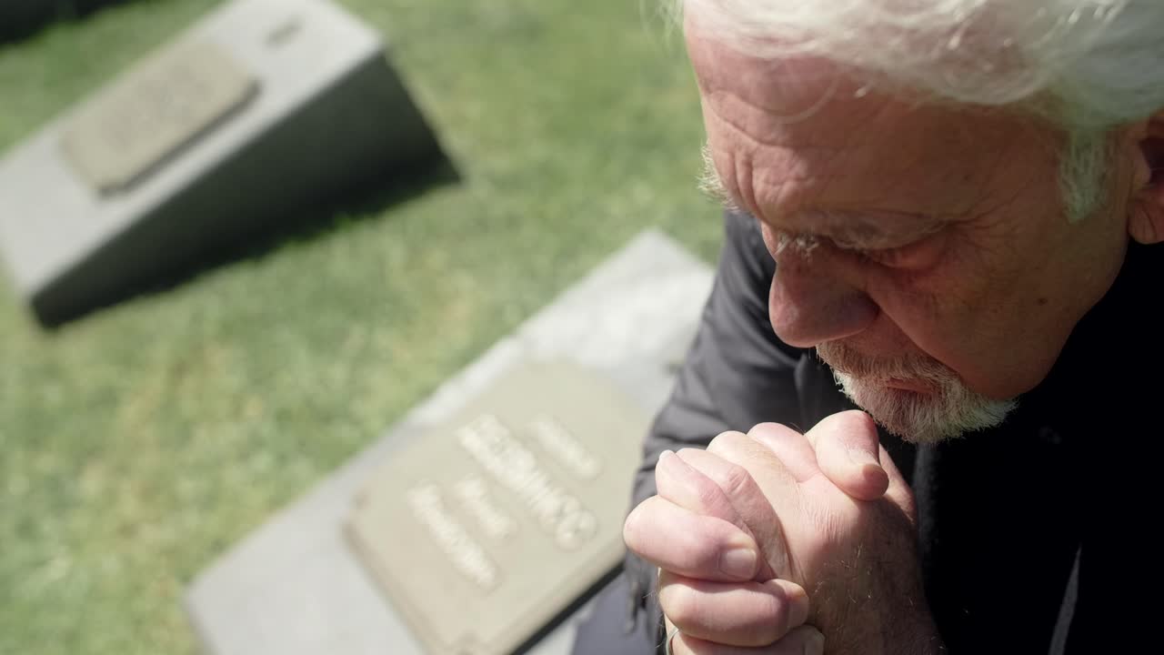 Elderly Man Mourns at Cemetery