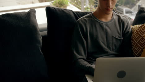 man using laptop at home 4k