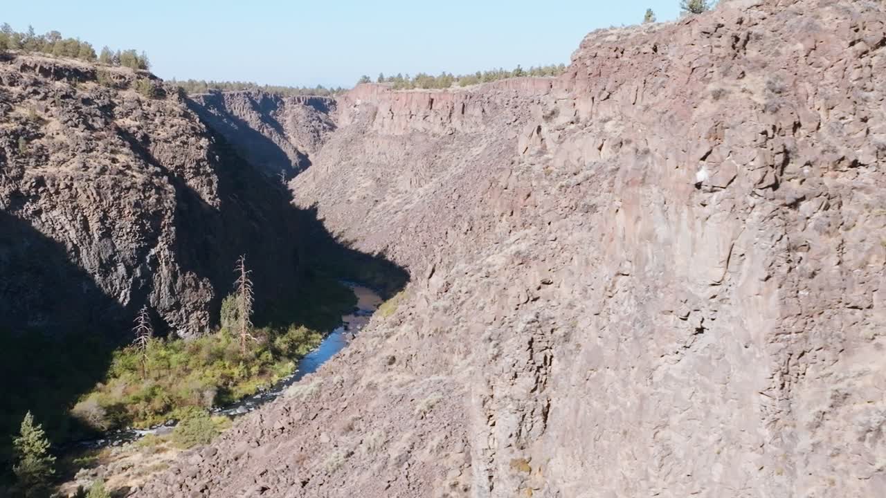 Aerial Reveal Cliffside Reveal of Crooked River Canyon with Rugged Arid Terrain