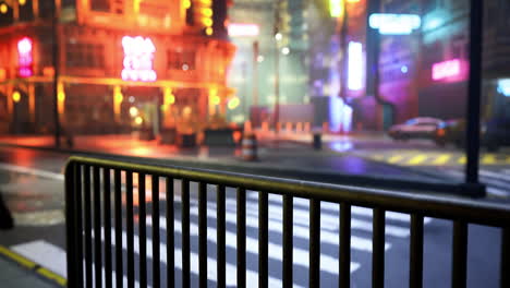 city street at night with neon lights and rain soaked pavement