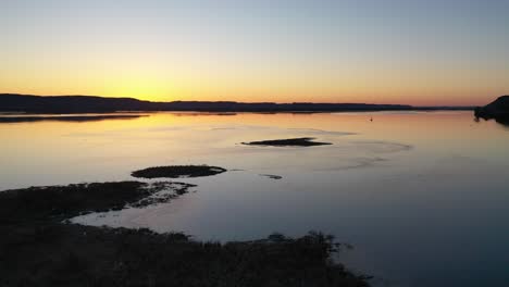 sunrise over a calm river with island