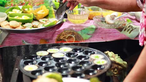 cooking thai coconut puddings at a floating market