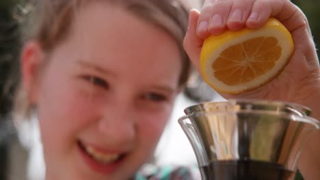 young girl squeezes lemon halve to make lemonade one hand 1000 fps phantom