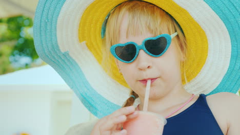 A-Cool-Girl-In-A-Hat-Drinks-A-Cocktail-From-A-Straw-In-A-Swimsuit-Resting-On-A-Deckchair-Rest-With-C