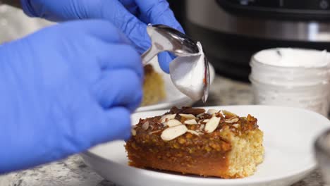 placing spoonful of icing on top of banana caramel cake slice