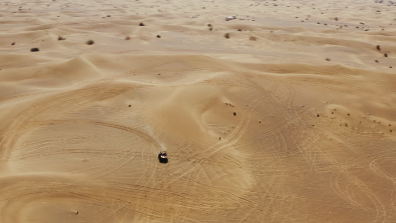 Off road sand buggy driving in immense open Arabic desert, travel activity, aerial