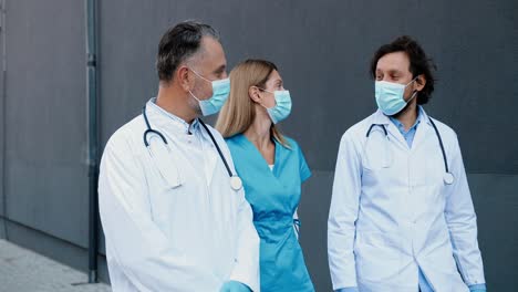 caucasian male and female doctors colleagues wearing medical masks