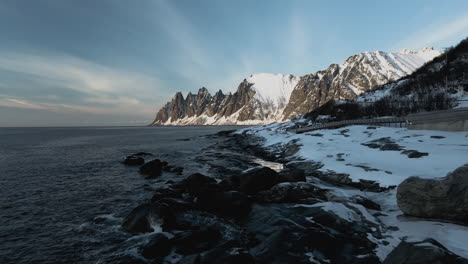 beautiful rocky mountain scenery in senja village norway - aerial shot