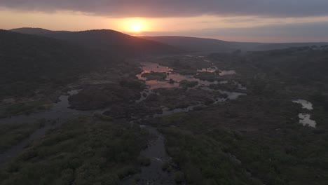 This-panoramic-drone-journey-soars-over-the-awakening-Komati-River,-showcasing-the-raw-beauty-of-South-Africa's-wilderness