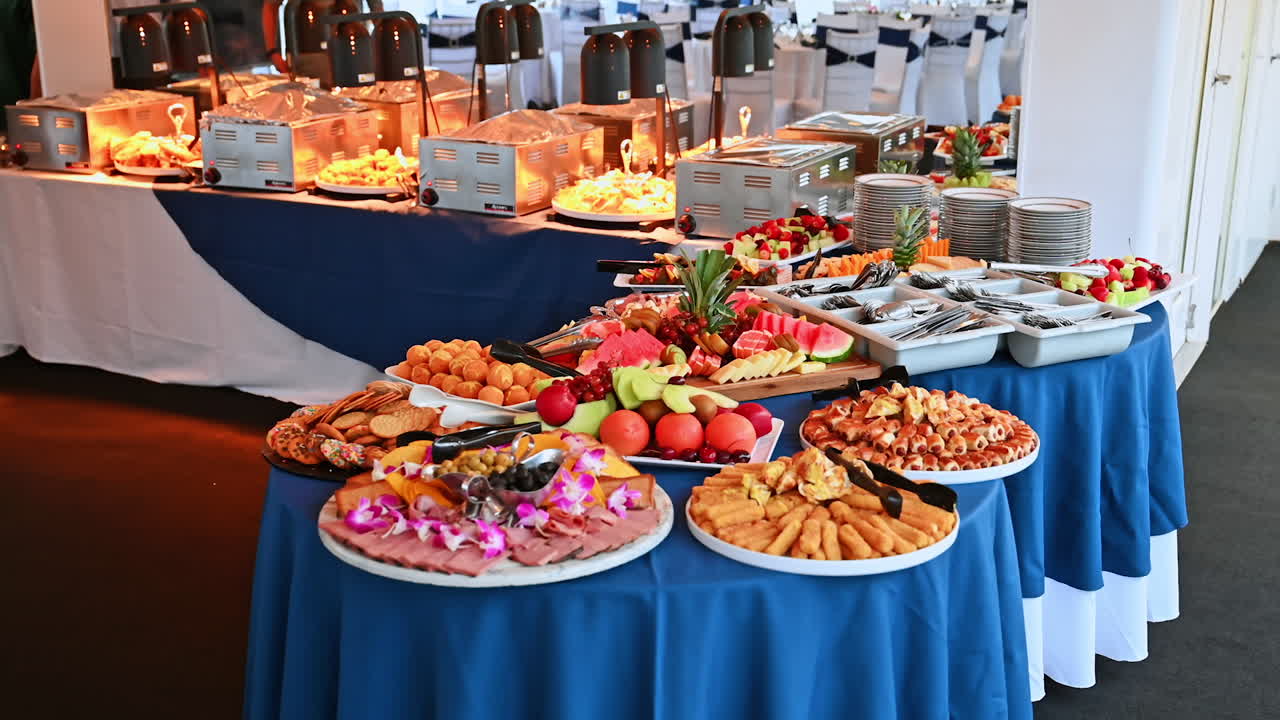 Banquet buffet with fruits, pastries, and appetizers. Luxury cruise buffet with colorful fruits, pastries, and snacks displayed on elegant tables