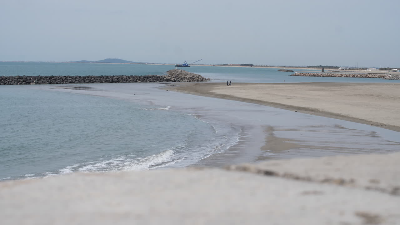 Beach in winter Sete Mediterranean sea France concrete jetty