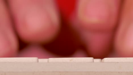 fingers typing on keyboard, busy work scene, rack focus, extreme close up