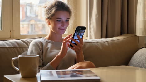 woman using phone on couch