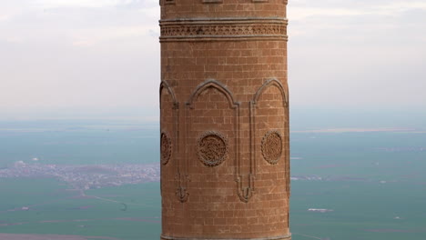 mardin ulu camii's minaret on a cloudy day after the rain, over looking mesopotamia from bottom-up