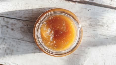 Top-View-Of-Ginger-Peach-Preserves-Jar-On-Rustic-Table