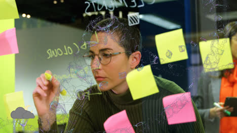 animation of connected dots forming abstract shape over caucasian woman writing on glass wall