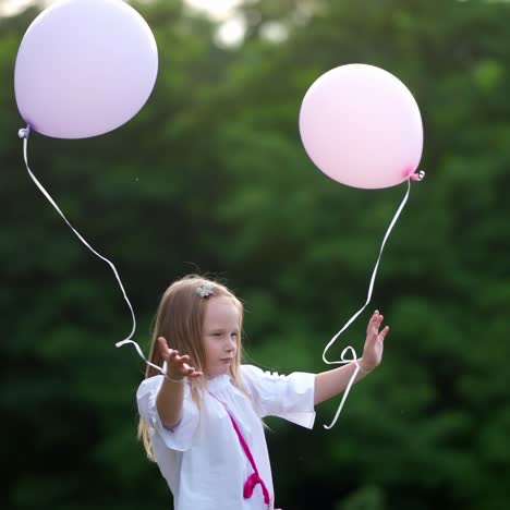Girl with balloons on nature