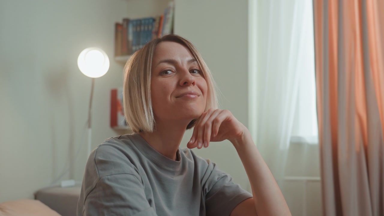 Woman with braids enjoying music, sunlit curtain backdrop and lamp glow, candid smiles and flirtatious gestures, casual tee, upbeat lofi ambiance, confident charm, playful selfcare moment, amateur