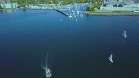 aerial view sea yachts standing at parking on background hills and sky landscape. ship sailing. aerial view of sea full of boats, fresh water sailing contest.