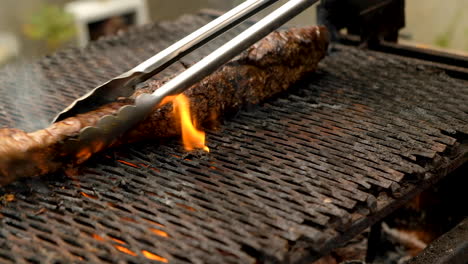 venison backstrap  barbecued over flames on open fire