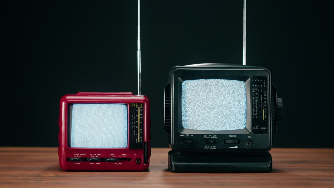 Two vintage televisions on a table
