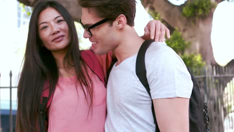 smiling hipster couple embracing each other