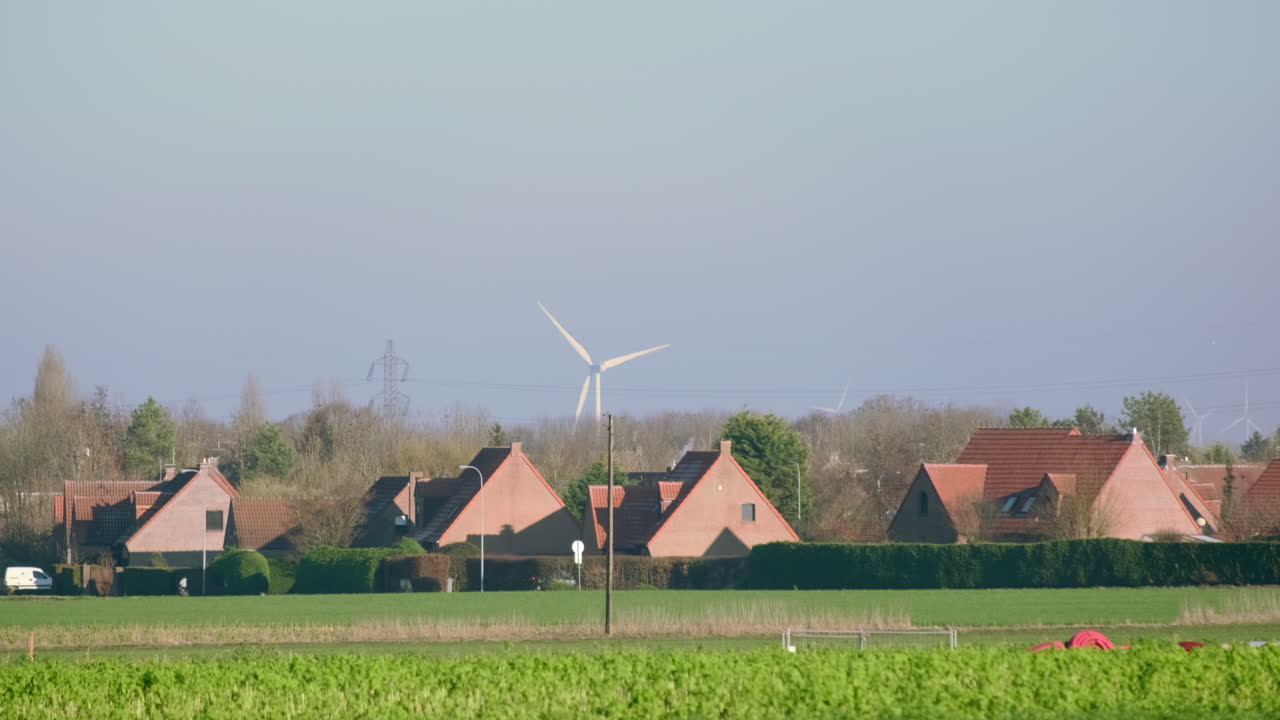 Win turbine rotating behind a small french lot