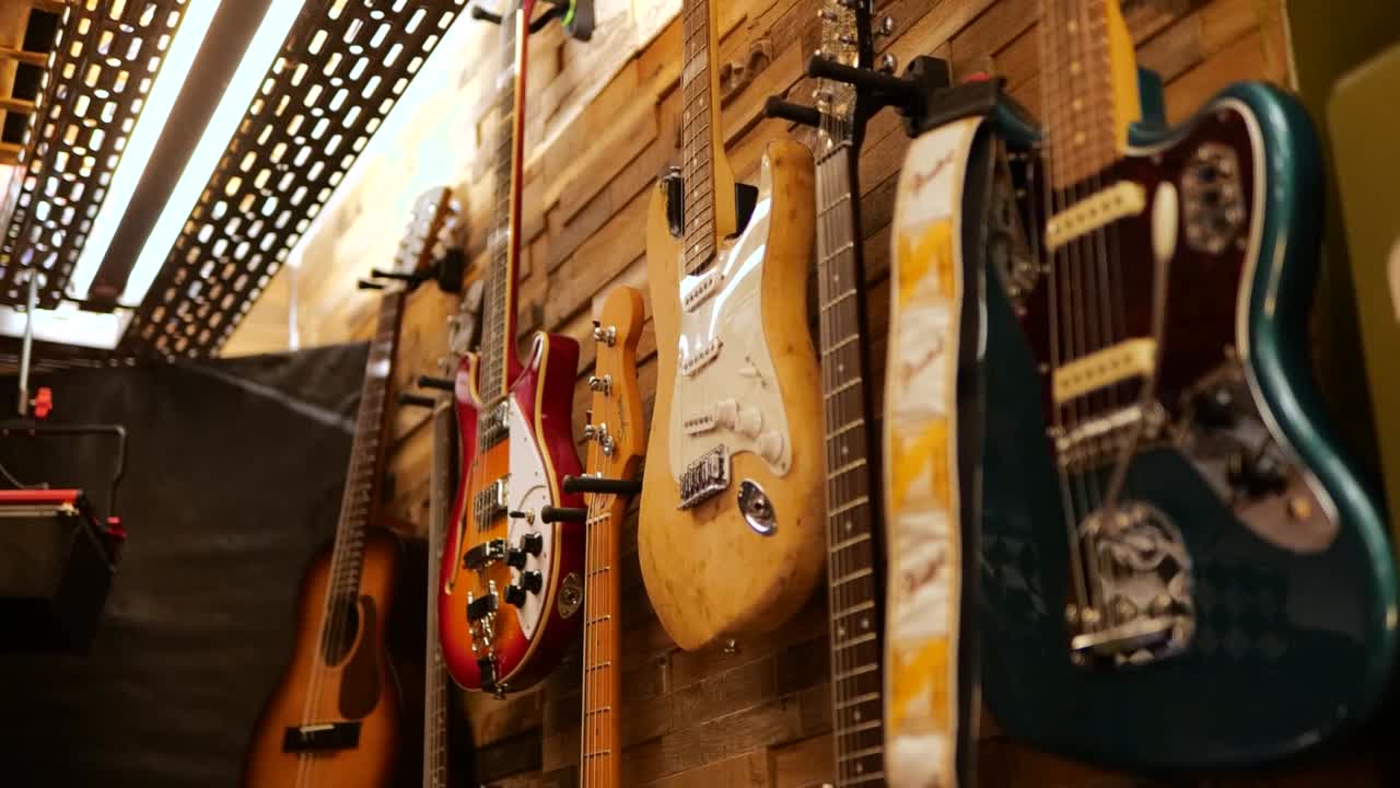 Electric guitars on display in a music studio, hanging on the wall