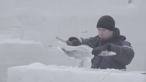 ice carver working on an ice sculpture