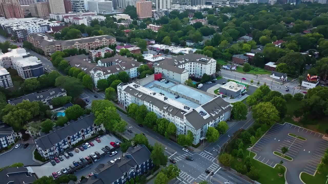 Midtown Atlanta green space with commercial skyline buildings at back, establishing drone shot
