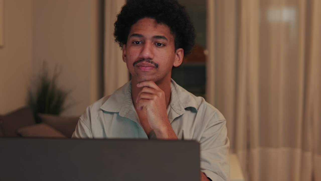 Man using a laptop while thinking