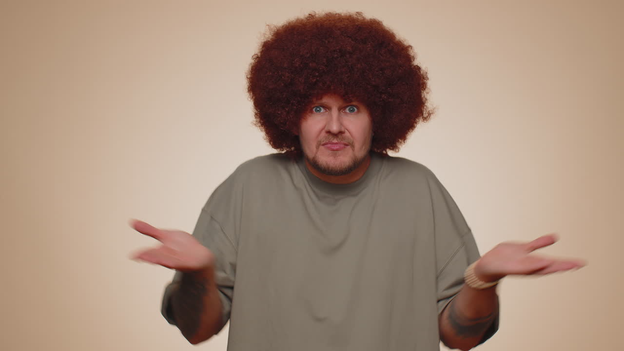 Man raising hands in indignant expression asking why what reason of failure demonstrating disbelief