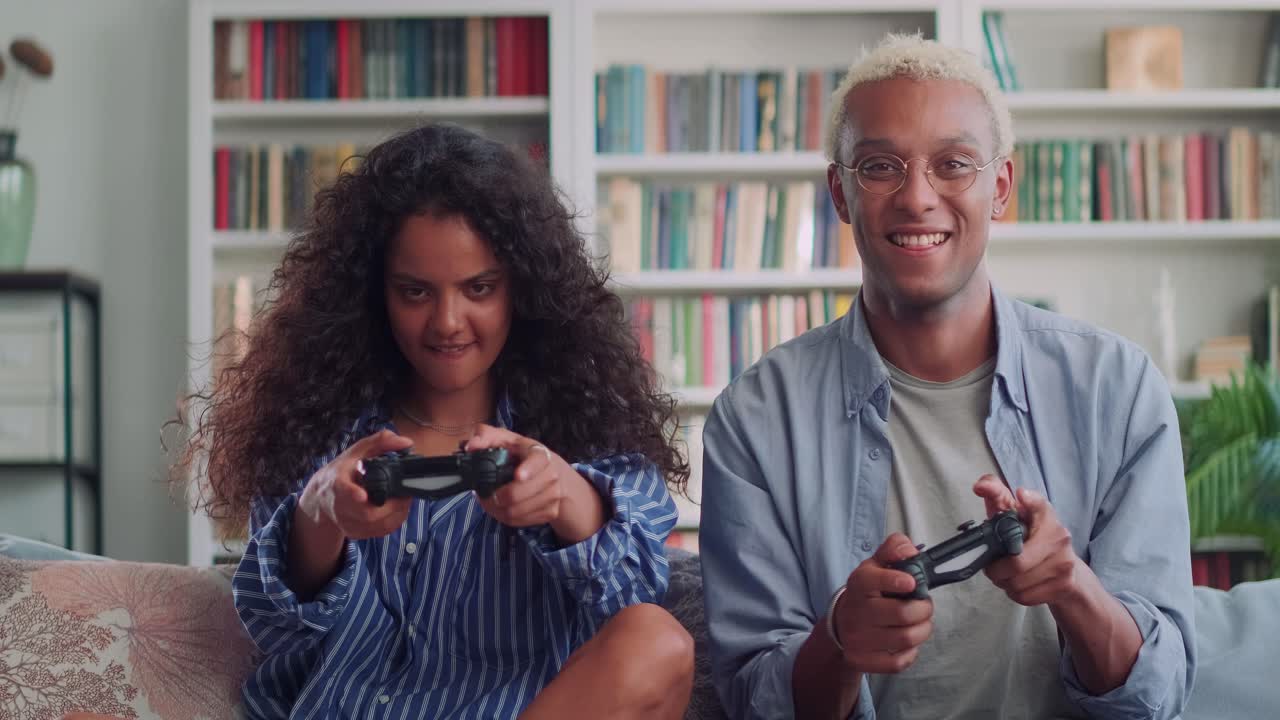 Multiracial young friends african american man and indian woman play video games