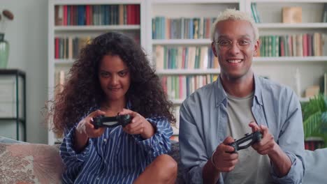 multiracial young friends african american man and indian woman play video games