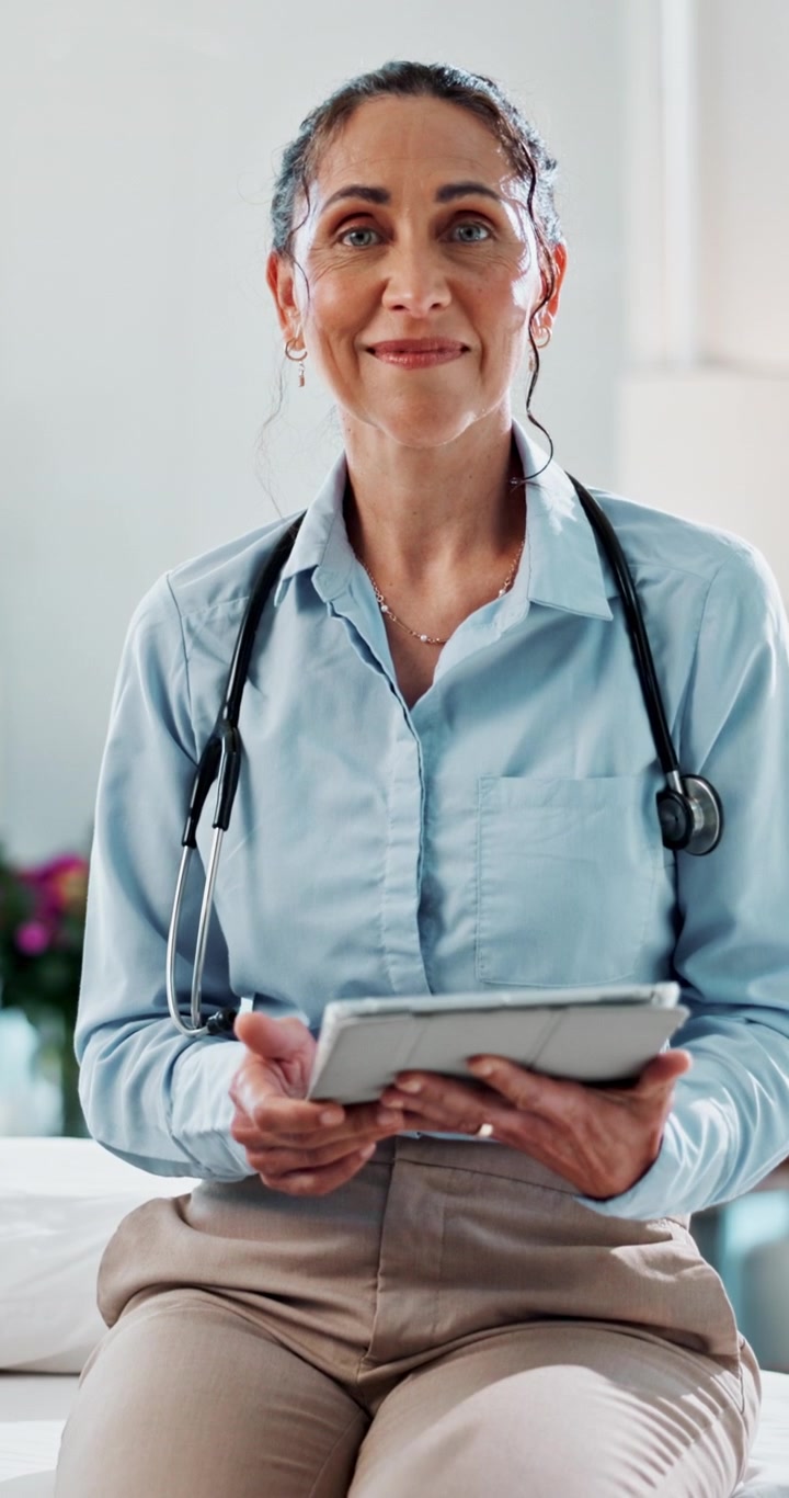 Female Doctor Using Tablet in Medical Office