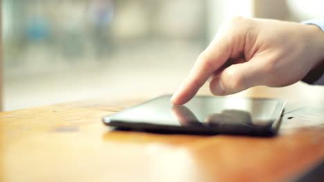 finger touching touchscreen tablet computer closeup browsing