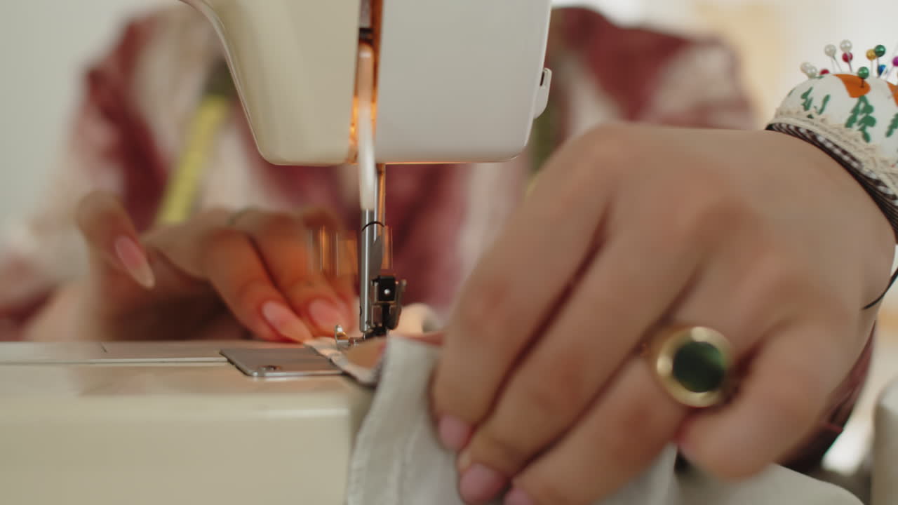 Hands of Atelier Worker Sewing Dress on Sewing Machine