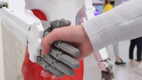 the robot of the future artificial virtual intelligence shakes hands with man the robot machine of the future artificial virtual intelligence shakes hands with man modern technology