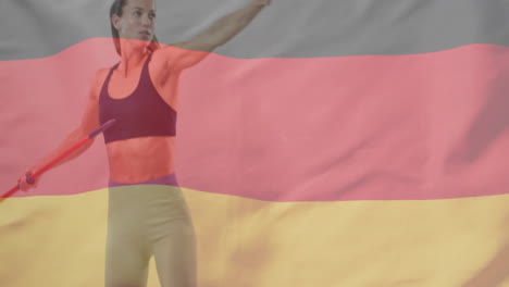 animation of flag of germany over caucasian female javelin thrower