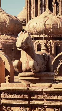 a stone horse statue atop a fantasy building