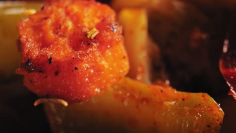 cinematic close-up of grilled vegetables including juicy squash and tender carrots