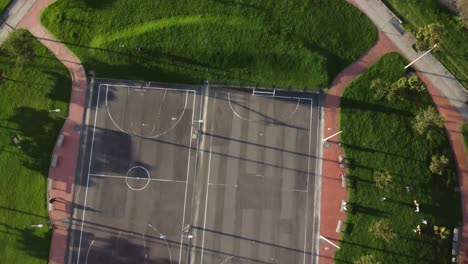 zenithal shot with dolly out of people playing in a park